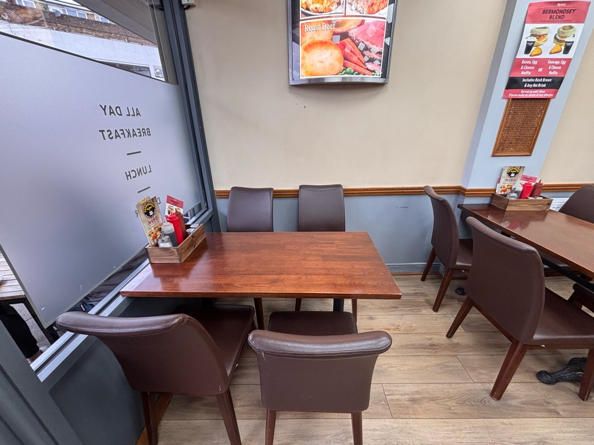 From entrance facing left. Tables and chairs ahead and at right.