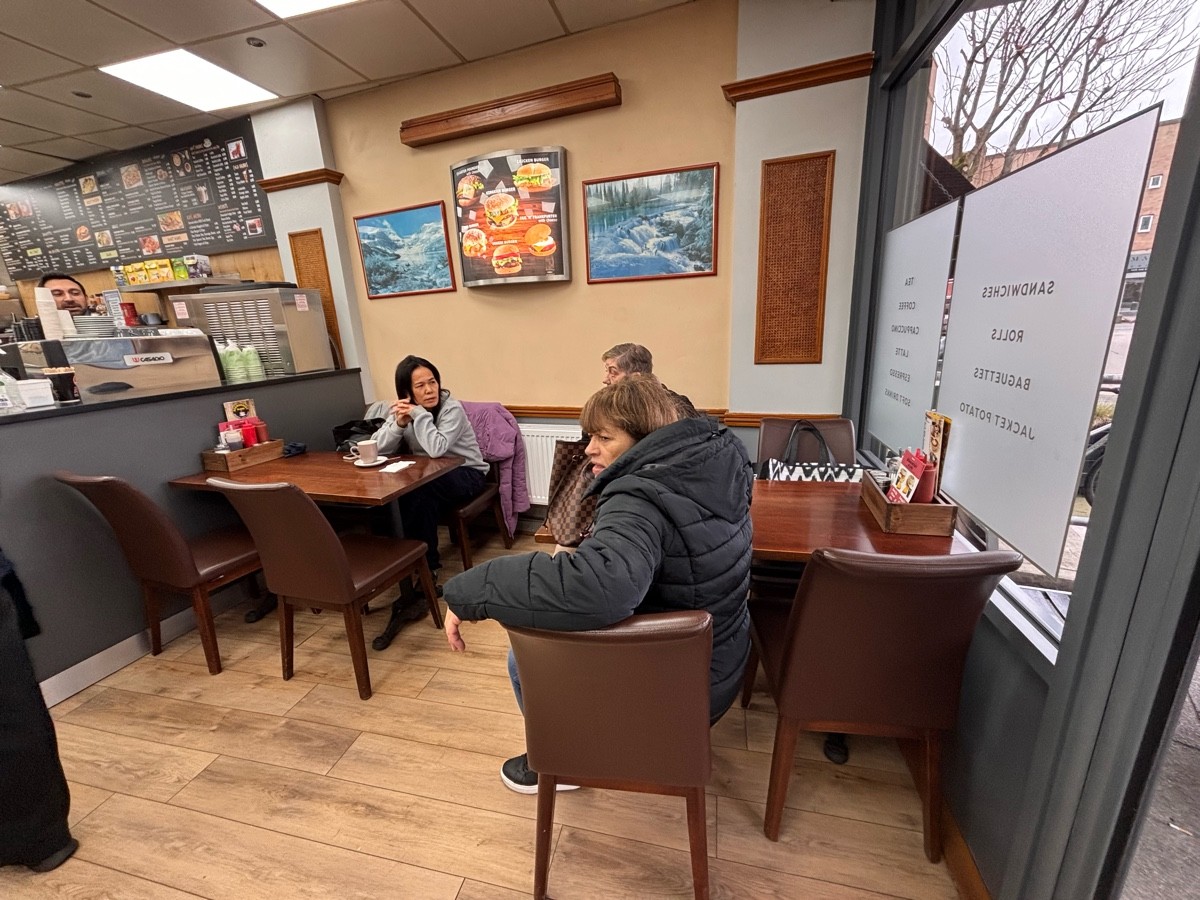From entrance facing right. Tables and chairs ahead and at left. Counter at back left.