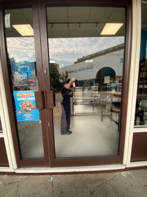Push glass door with handle in the left. One step leading to the entrance door.