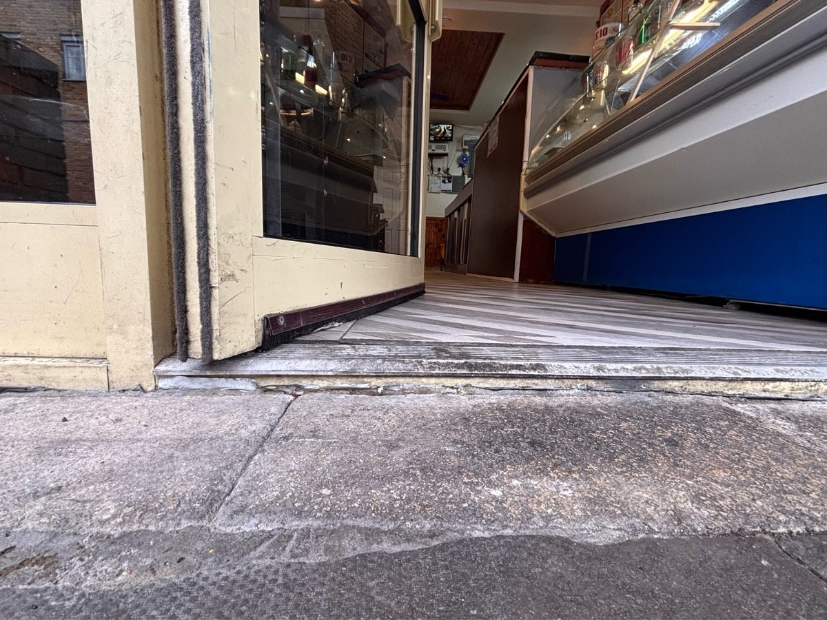 Small metal bump at foot of door.