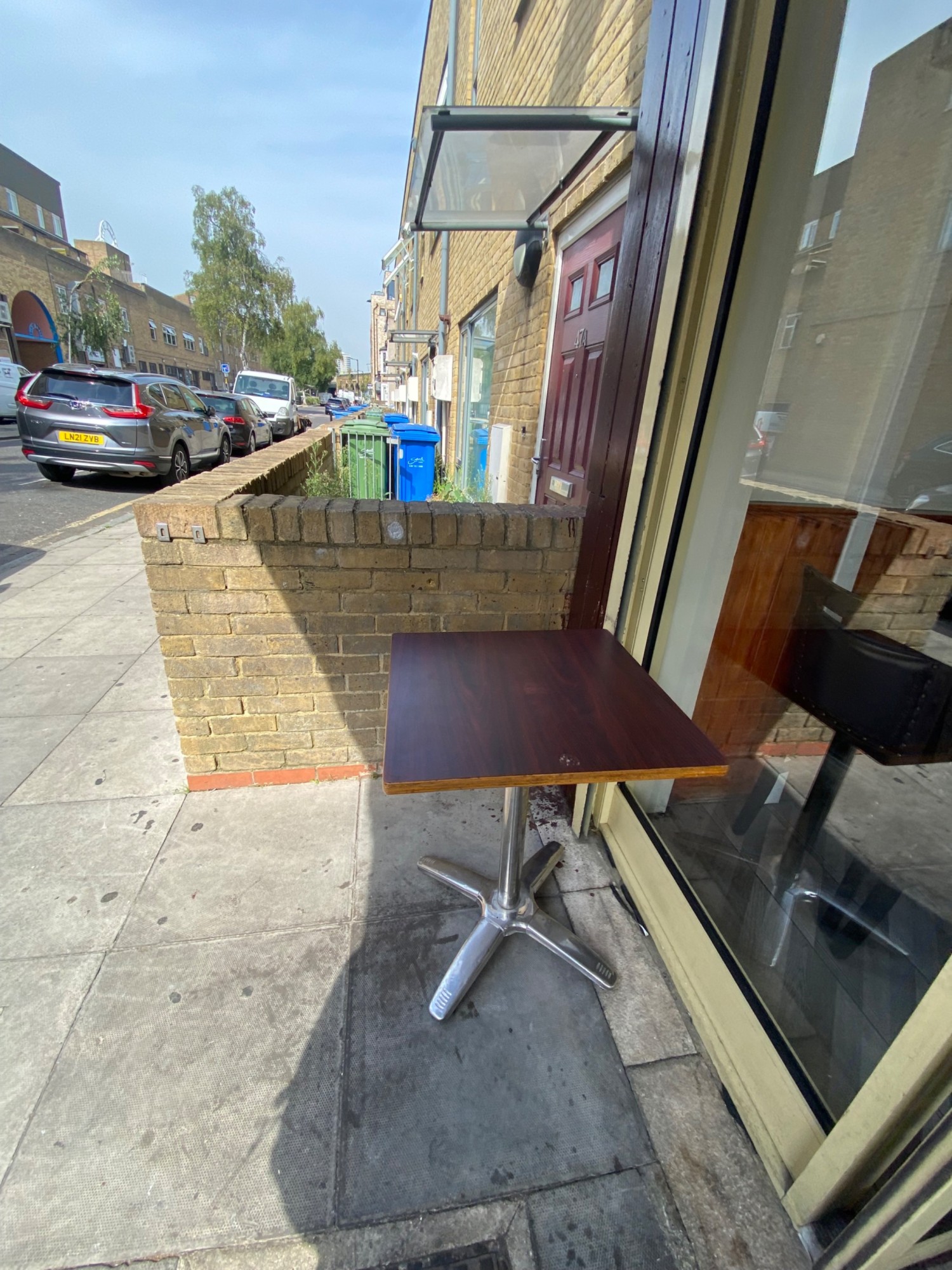 Looking left from entrance. Table to the right. Street to the left.