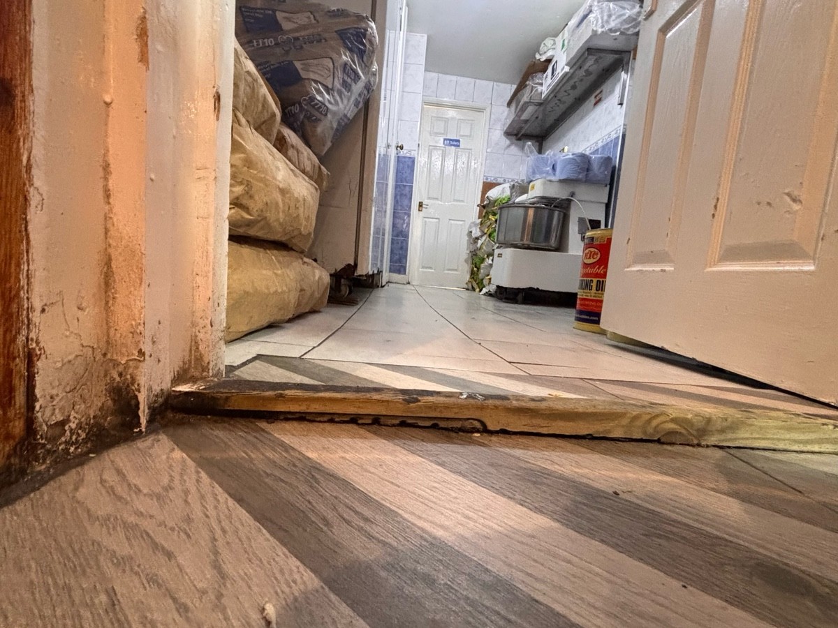 Small wooden bump at foot of door.