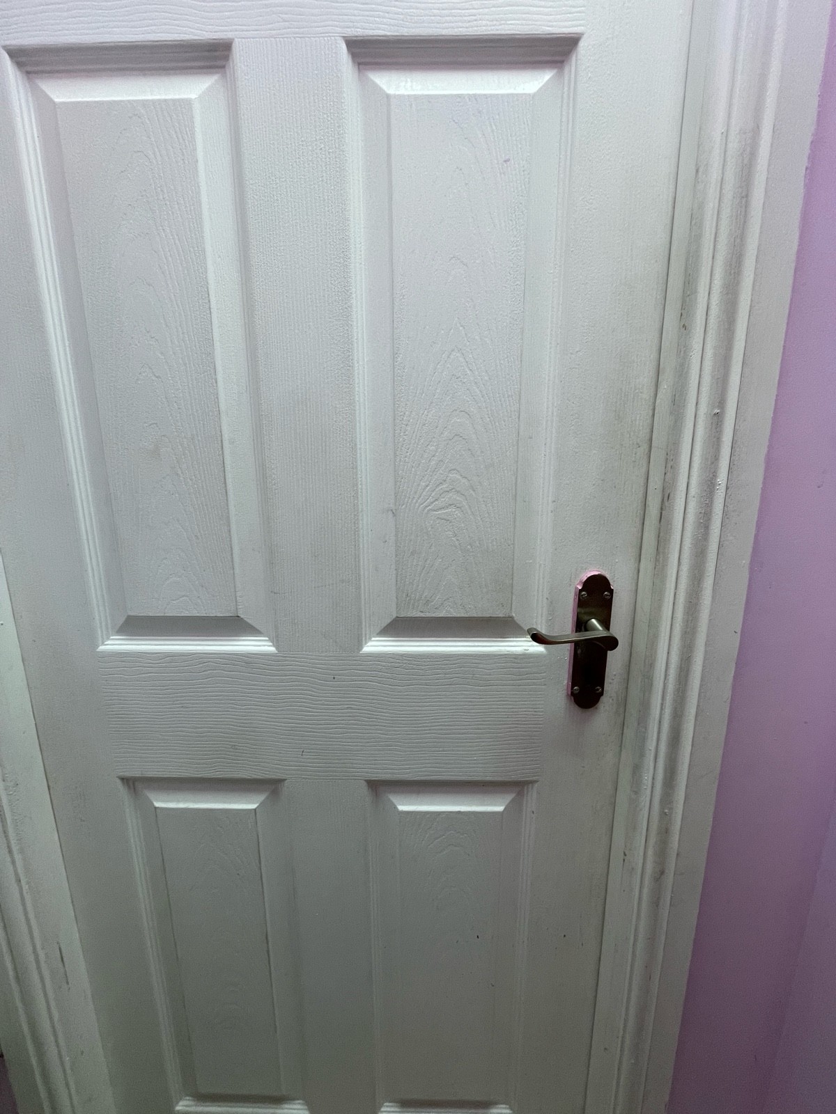 From sink facing right. Second bathroom door ahead. White wooden door. Push from silver handle on right to open.