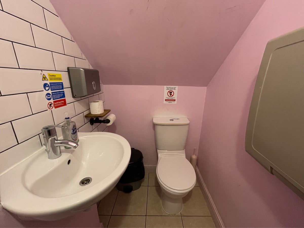 From after door facing straight. Sink on left. Toilet at back right.