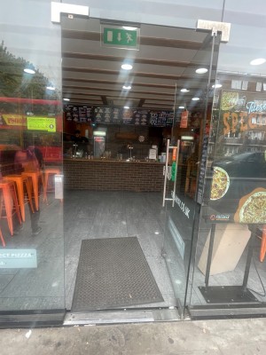 From street looking straight at entrance. Small bumps to enter.  Glass door push to enter handle on left side.