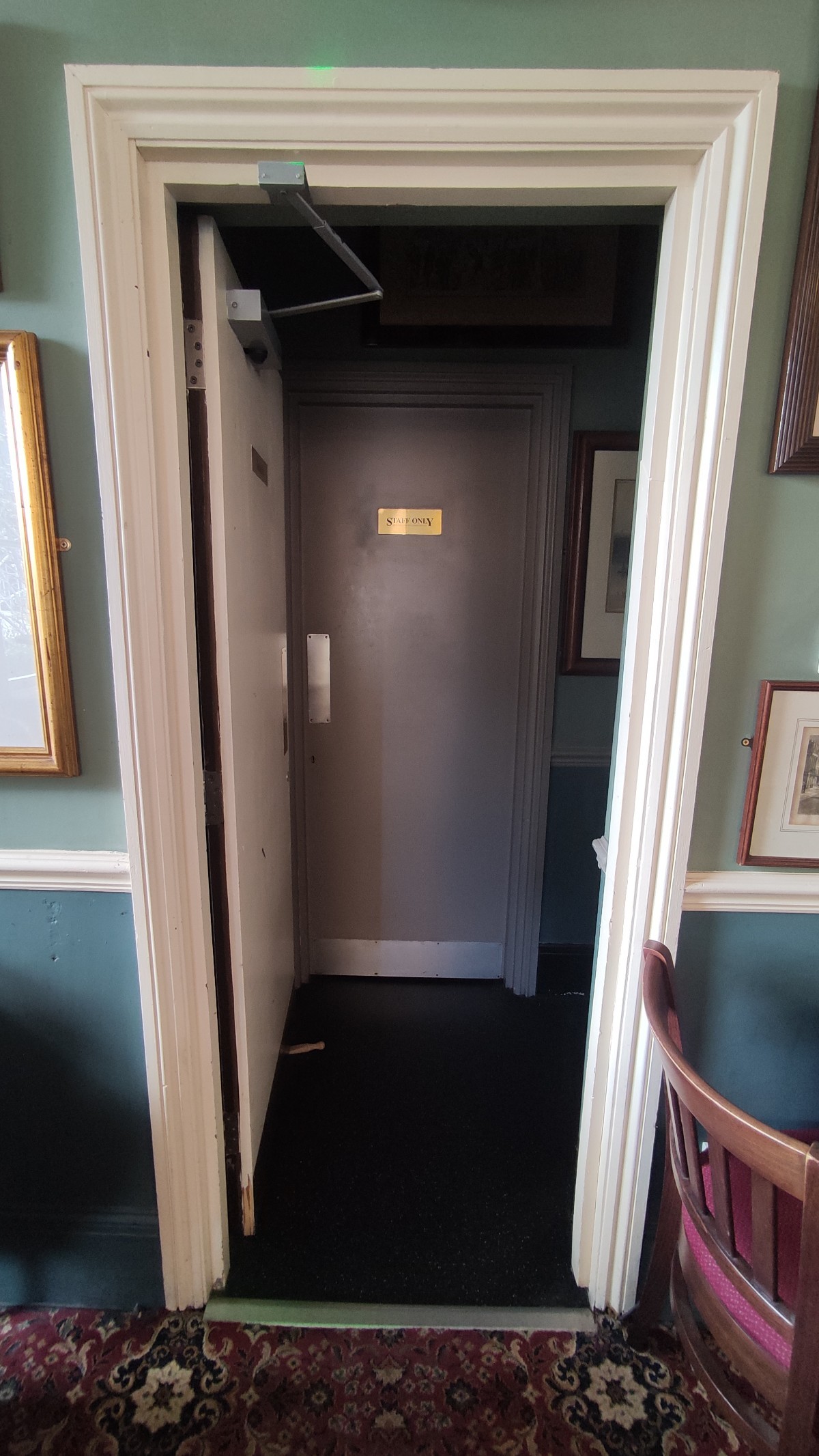 From right end of upstairs area facing right. White door ahead. Push to right to open.