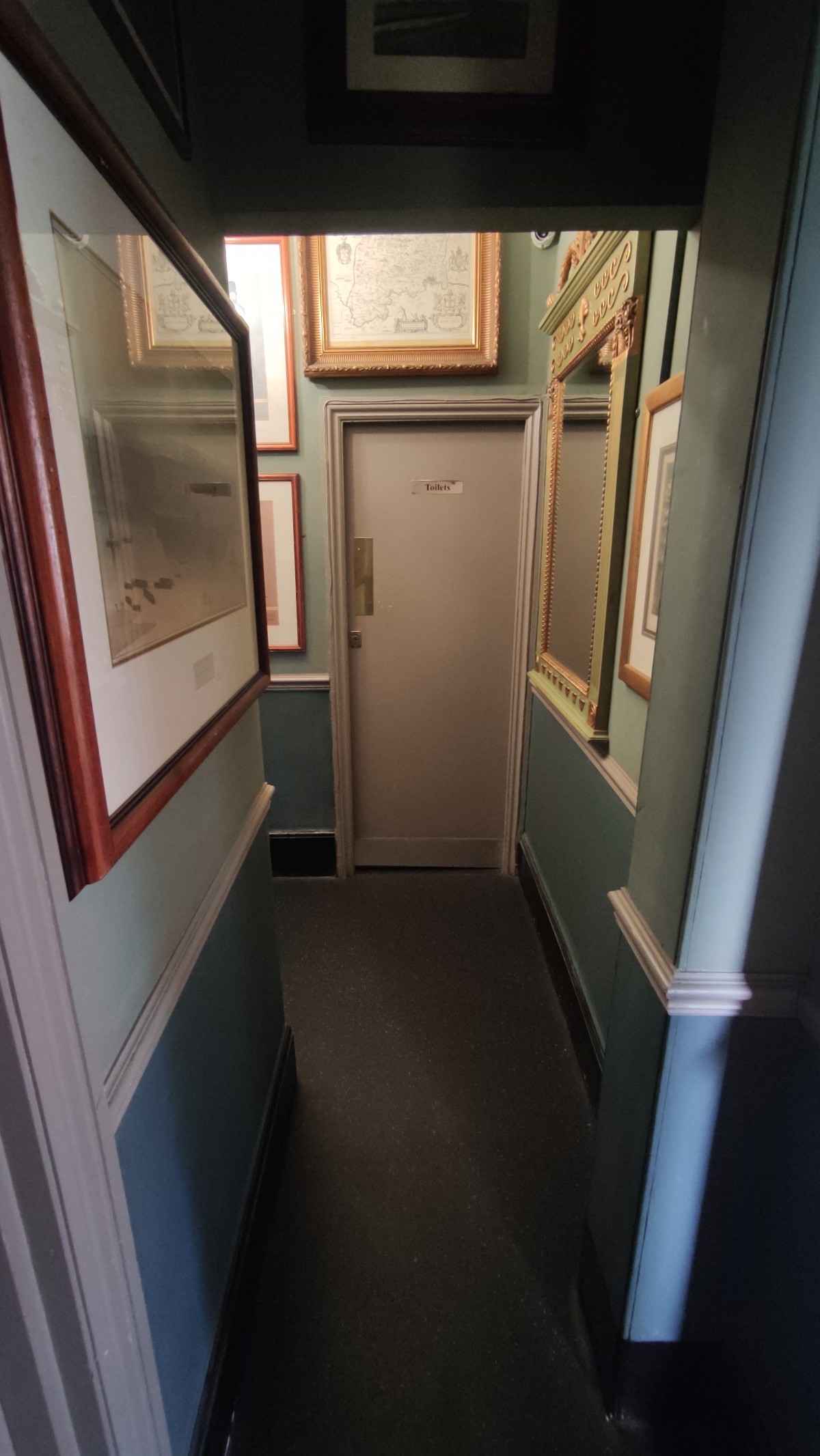 From door facing right. An open archway with narrow path ahead.