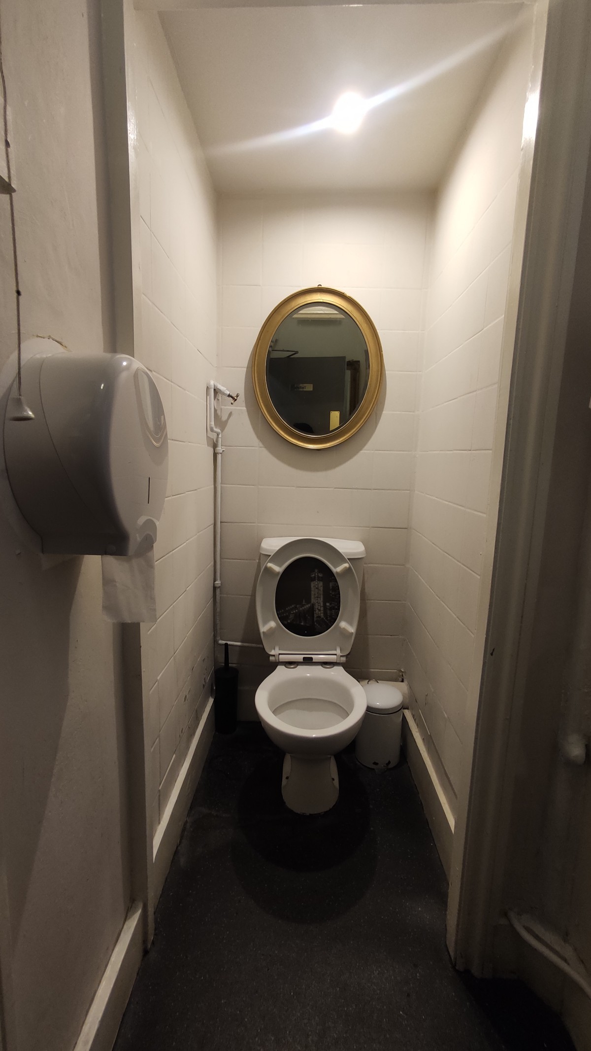 From door facing left. Pull cord on immediate left. Toilet at the back wall.