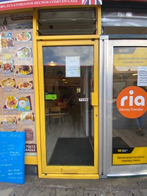 Push glass door with handle on the right. Small step leading to entrance door.