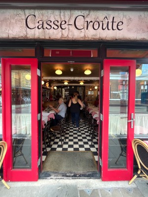Glass doors with red frame. Pull silver, metal handles in middle to open.