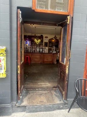 From the street looking at entrance to main area. Double door. Glass and wood pull to open in the centre.