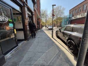 From sidewalk on left of venue facing right. Path down center to kiosk on left. Blue badge parking on right.