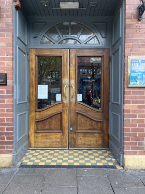 Main entrance first set of double doors. Open outwards from the centre.