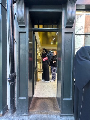 Single dark grey wooden door with large glass panel and silver pad on right. Push to open.
