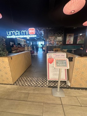 From entrance with low wall on the left and right hand side. Small built in ramp straight ahead to the left. Signage on the right.