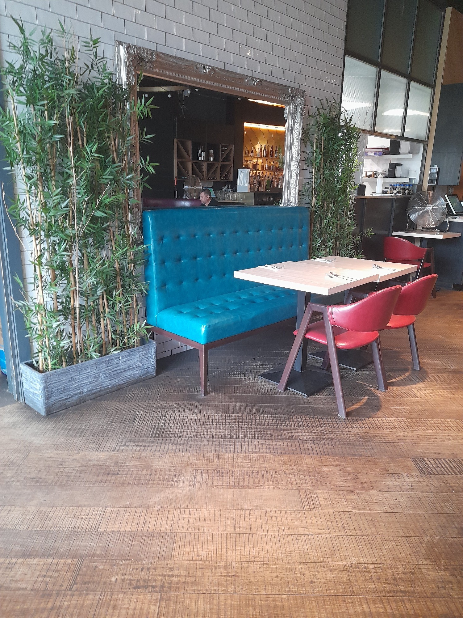 Reflective surfaces fixed seating and removable chair with plenty of turning space