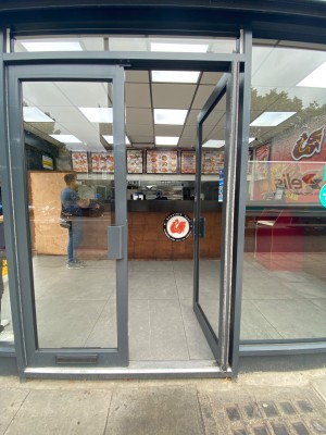 Grey framed glass doors. Push grey handles in centre to open.