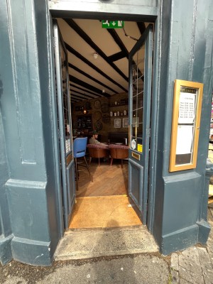 Glass doors with blue, wooden frames. Push from middle to open.