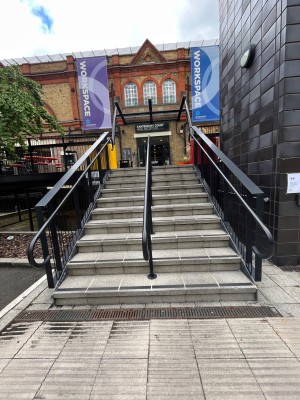 Steps leading to main area. Hand rail on left middle and right.
