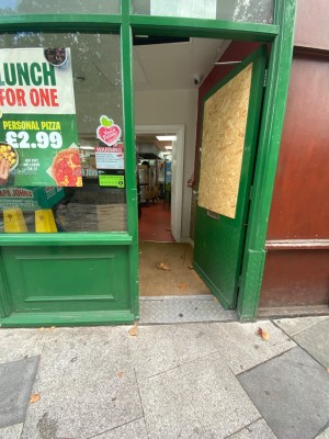 Green door with metal push to open handle on left.