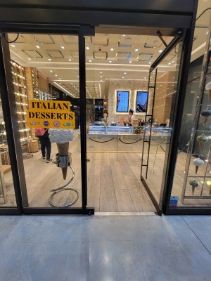 Glass doors with black frame. Push handles in centre to open.