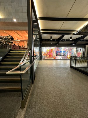 From right of stairs facing straight. Path ahead leads to lift to back left.