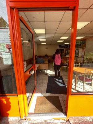 Orange and glass paneled door. Pull handle on right to open.
