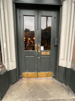 Double pull doors with gold handles in middle.