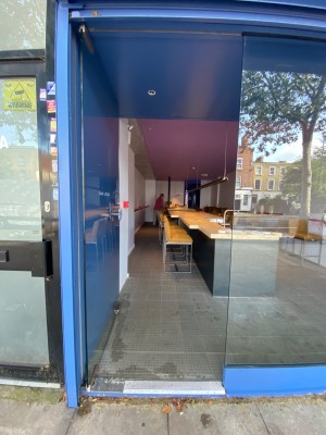 Push glass door with handle on the right.