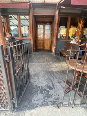 From the street looking straight. Gate. Open by pushing on right side.