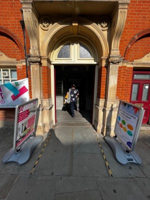 Built in ramp up followed by red wooden doors. Push from middle to open.