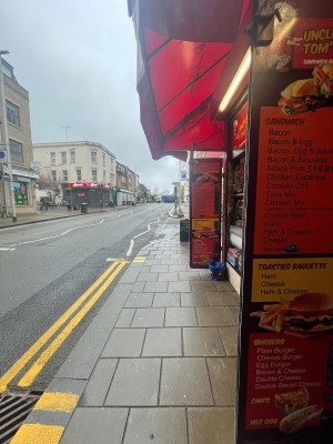 From right of venue on street facing left. Till and open kitchen on right.
