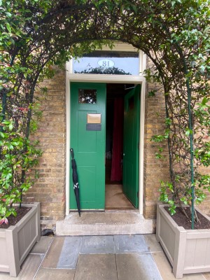 Green wooden doors. Push from centre to open.