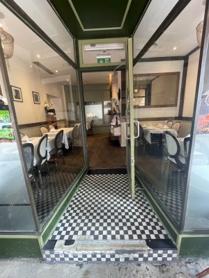 Pull door from left to open. Green door and black doorframe.