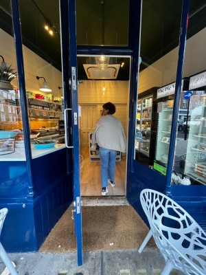 Glass door with blue frame. Pull silver handle on right to open.