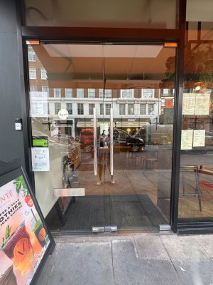 Glass double doors. Pull from middle to open. Small bump at foot of doors.