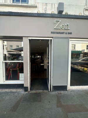 Single glass door with handle on the left. Push.