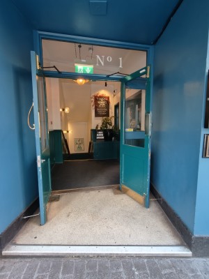 Blue framed glass preceding doors. Pull golden handles in centre to open.