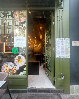 Single glass door with handle on the left. Push.