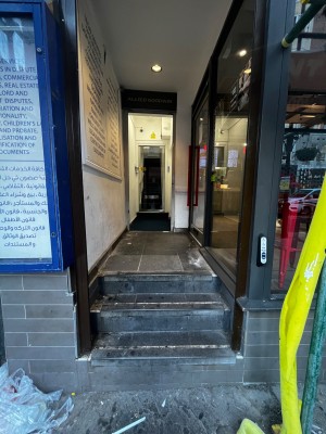 Three steps up to door on right. Doorbell for assistance on right.