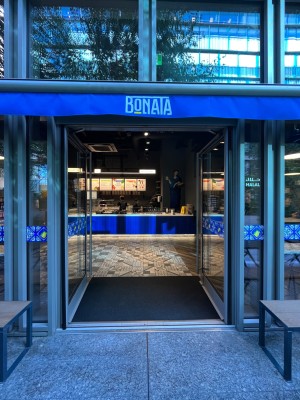 Glass door with metal doorframe. Push open from the middle.
