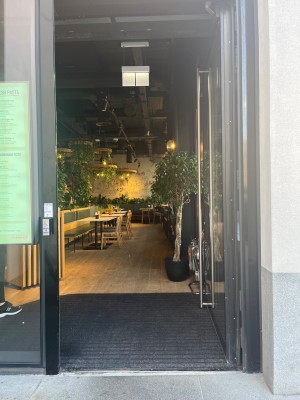 Glass door with black frame. Pull from left to open.