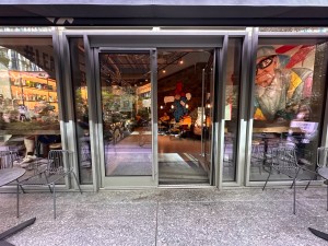 Double glass doors with metal doorframes. Push to open from middle.