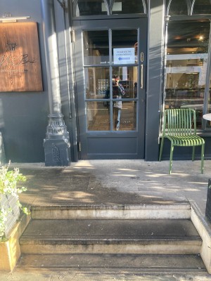 From sidewalk facing venue. Two steps up ahead.