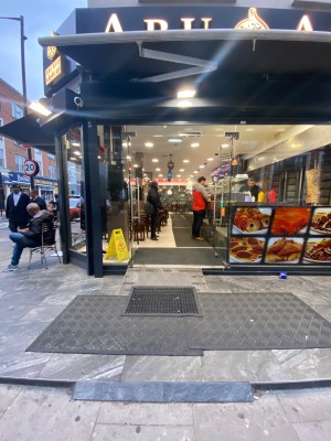 2 built in ramps before entrance. Then double glass doors. Push from middle to open.