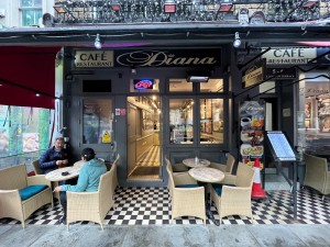 Small bump leading up to outdoor seating platform, from street. Door straight ahead.