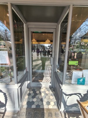 Grey framed glass door. Pull grey handle on right to open.