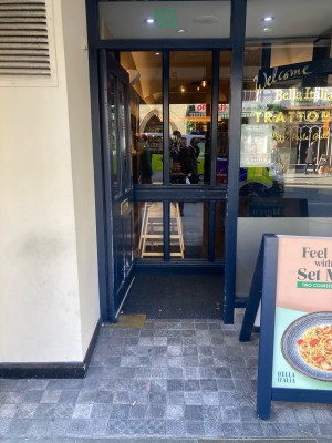 Dark blue wooden door with glass panels ahead. Push door from right to open.