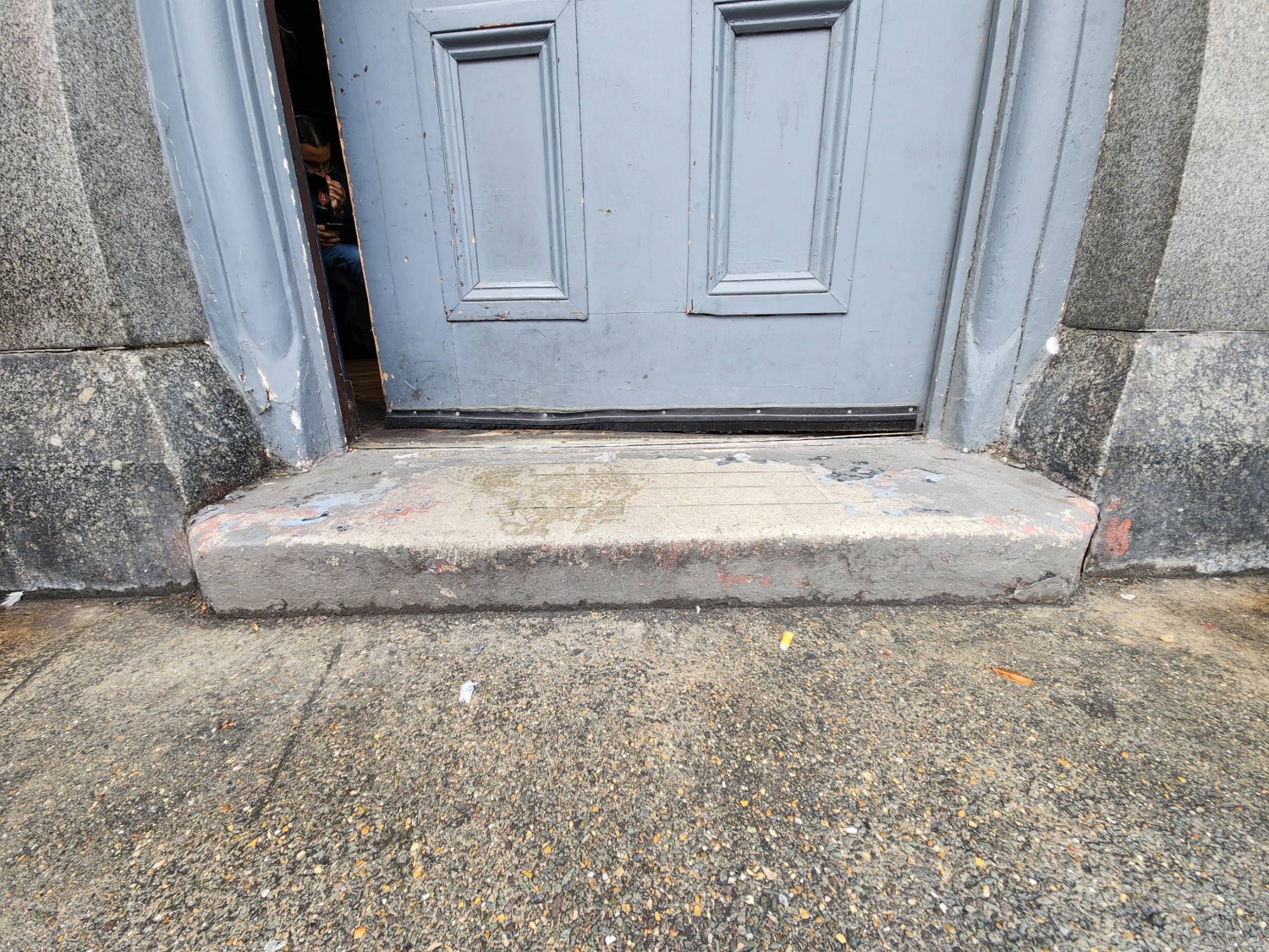 Single step at foot of door.
