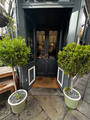 Glass double doors. Push from middle to open. Plants either side.